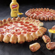 Image for article titled Pizza Hut is going to offer its US customers a pizza with hot dogs in the crust